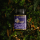 Creamed Tawari Honey from Manawa Honey NZ, award-winning honey jar surrounded by native New Zealand foliage.
