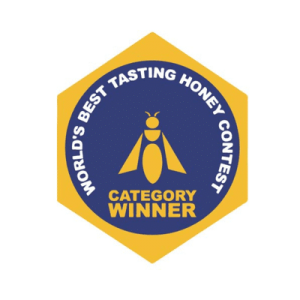 Manawa Honey NZ - Award-Winner at the World's Best Tasting Honey Contest The official award logo for the World's Best Tasting Honey Contest, a gold and blue hexagonal badge confirming that Manawa Honey NZ is a Category Winner for its premium New Zealand honey.